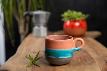 coffee cups with mocha pot on a wooden table