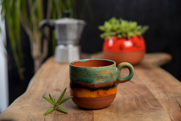 coffee cups with mocha pot on a wooden table