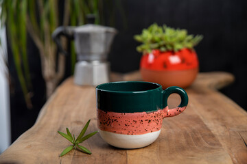coffee cups with mocha pot on a wooden table