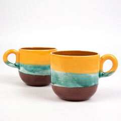 colorful coffee cups on yellow background isolated