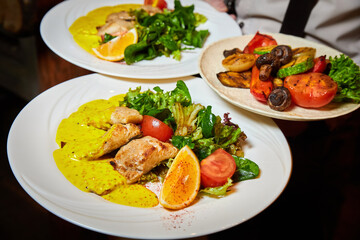 Baked pelengas fillet with salad mix with mustard-cream sauce. Close-up, selective focus