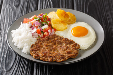 Silpancho is a typical popular Bolivian food from the city of Cochabamba closeup in the plate on the table. Horizontal