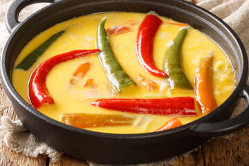 National Dish of Bhutan Ema Datshi closeup in the pan on the table. horizontal