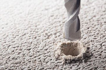 drill bit make holes in concrete wall with industrial drill. Building work industry.