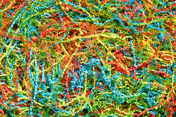 Color shredded confetti paper gift box filler. Bright colored background.