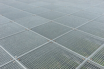 Grating platform. Square industrial galvanized metal grid. Metal background