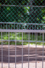 Naklejka premium Metal fence of a children's playground close-up