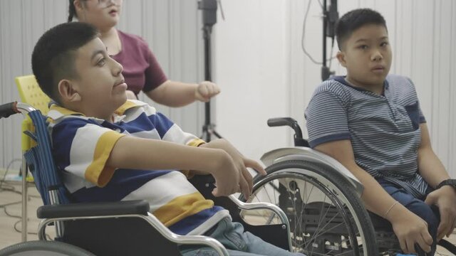 Group Asian handicapped child in wheelchair in classroom. Activities of children with autism in learning in school. Develop brain and imagination for children.