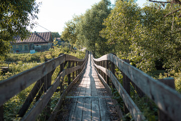 Fototapeta premium suspension bridge on cables across the river