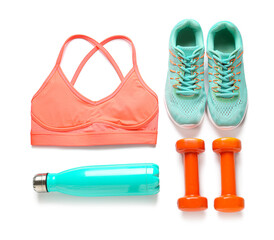 Sport shoes, bottle of water, dumbbells and top on white background