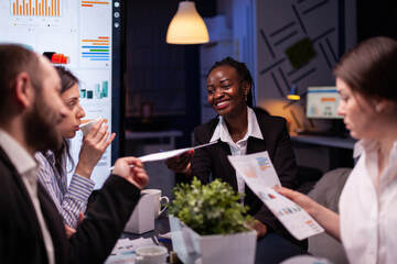 Workaholics focused multi-ethnic businesspeople overworking in company office meeting room...
