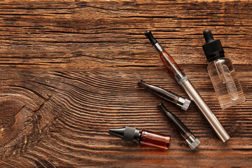 Electronic cigarette with oil on wooden background