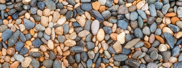 Panorama of multi colored river pebbles for use as a background