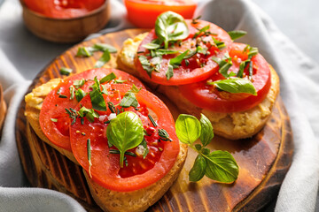 Tasty bruschettas with tomato and hummus on color background, closeup