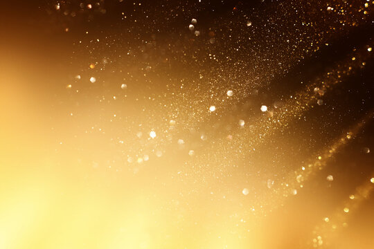 background of abstract gold and black glitter lights. defocused