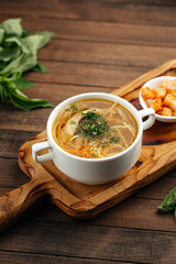 Chicken noodle soup with croutons on wooden background