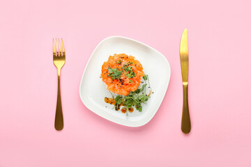 Delicious salmon tartar on color background