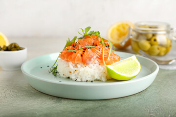 Delicious salmon tartar on grunge background