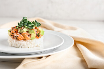 Delicious salmon tartar on light background, closeup