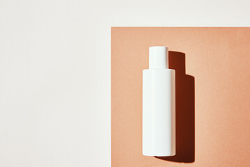 Natural cosmetics mock up. Beauty product concept. White bottle on pastel background