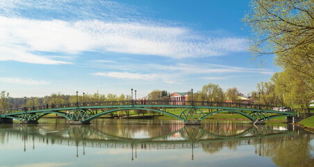 Graceful bridge with lanterns and beautiful reflection in the water