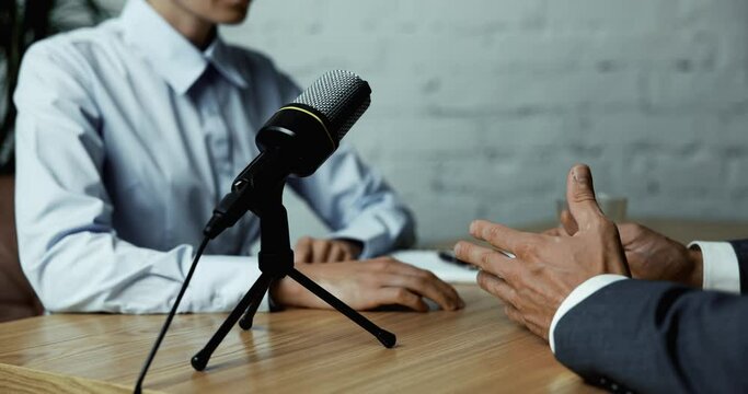 podcast interview recording - radio host discussion with businessman in broadcasting studio. copy space