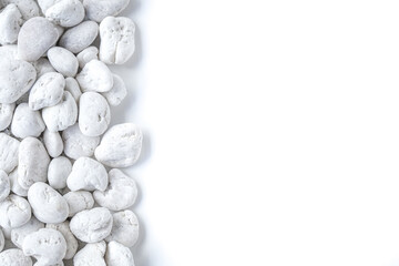 White pebbles stone on white background with copy space 