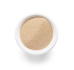 Bowl with active dry yeast on white background