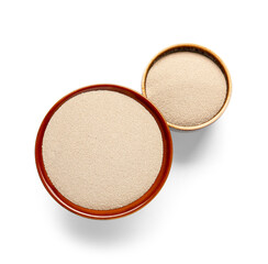 Bowls with active dry yeast on white background
