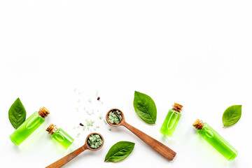 Tea tree aroma essential oil with tea salt with green leaves