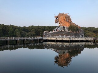 Hue, Vietnam, January 23, 2020, Dragon head in a abandoned Waterpark, Slide and swimming pool left...