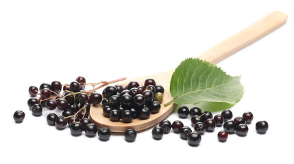 Elderberries, elder berries pile with green leaf and wooden spoon, isolated on white background