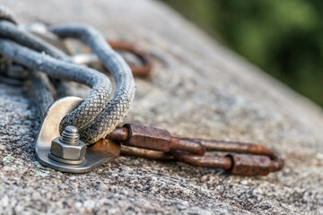 Closeup shot of a rope attached to the rock for rock climbing in Ticino, Switzerland