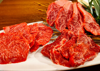 Close-up sliced wagyu marbled beef on plate.
