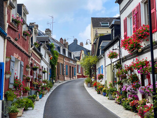 Saint-Valery-sur-Somme, France, August 15, 2020 - Beautiful flowered traditional street...