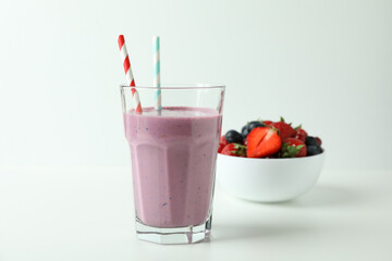 Glass of smoothie and ingredients on white background