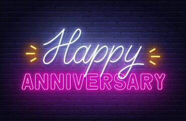 Happy anniversary neon text. Greeting card on brick wall background.