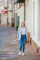 Portrait of a beautiful young woman in a European city. Makes purchases. Tourism. Summer.