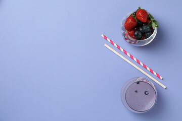 Blueberry smoothie, ingredients and straws on violet background