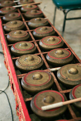 Set of small brass gongs called talempong, a traditional music instrument of minangkabau culture from west sumatra, Indonesia. No people. Selective focus. Top view. - obrazy, fototapety, plakaty