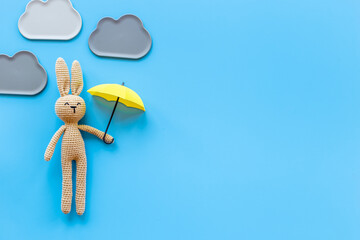 Knitted baby toy rabbit for newborn - background for baby shower