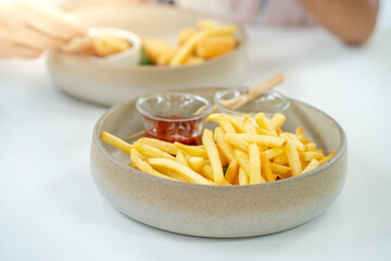 Bowl French fries on table background.
