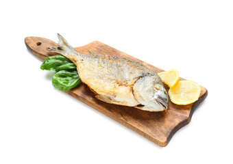 Wooden board with fried dorado on white background