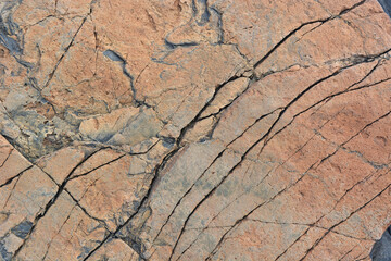 Natural orange stone with cracks, close-up