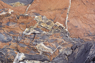 The stone is purple with orange and with a beautiful pattern