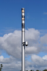Obraz premium Modern Outdoor Lighting Pole against Blue Cloudy Sky
