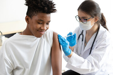 young african man getting a vaccine from doctor, to build up or maintain immunity