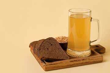 Mug of fresh kvass on color background