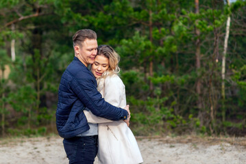 Fototapeta premium Happy loving couple enjoying of happiness love and tenderness, dating, romance.Couple hugging in love at spring park.