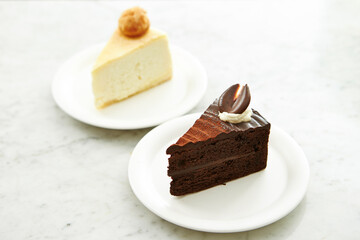 Cheesecake and chocolate cake on a plate 